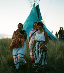 KD Chavez (far left) holding her daughter, walking with friends.